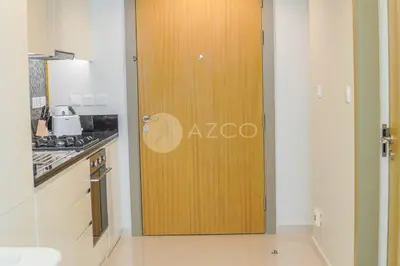 a wooden door in a kitchen next to a stove at Elegant Studio at Aykon City Tower - C in Dubai