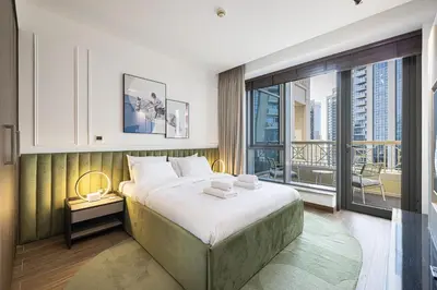 a bedroom with a large bed and a large window at The Signature Burj Khalifa View Residence with Terrace in Dubai
