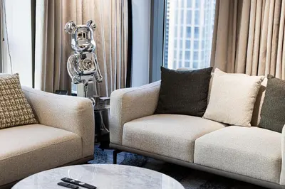 a living room with two chairs and a table at The Signature Burj Khalifa View Residence with Terrace in Dubai
