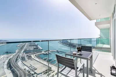 a view from the balcony of a building with a table and chairs at Marina Skyline View & Dubai Harbour Beachfront in Dubai