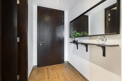 a hallway with a brown door and a wooden floor at Livin' Holidays - Luxury apartment in Dubai Marina in Dubai