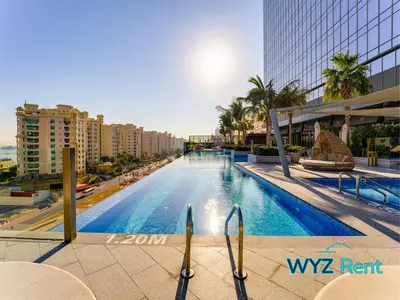 a large swimming pool in a city with buildings at Elegant 1BR in Palm Tower, Nakheel Mall, Sea View in Dubai