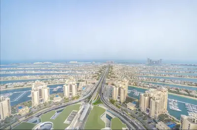 an aerial view of a city with tall buildings at Elegant 1BR in Palm Tower, Nakheel Mall, Sea View in Dubai