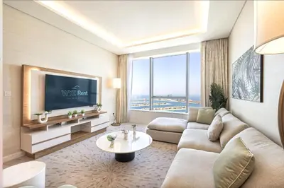 a living room with a couch and a tv at Elegant 1BR in Palm Tower, Nakheel Mall, Sea View in Dubai