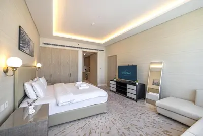 a hotel room with a bed and a television at Palm Tower Luxury Studio W Stunning Sea View in Dubai