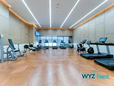 a gym with treadmills elliptical machines and treadleys at Palm Tower Luxury Studio W Stunning Sea View in Dubai