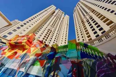 two tall buildings with a colorful display in between them at Your Scenic Dream Vacation in Dubai