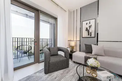 a living room with a couch and a chair and a window at Lavish 1BR Apartment at Summer at Creek Beach, Dubai Creek Harbor by Deluxe Holiday Homes in Dubai
