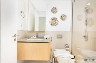 a bathroom with a sink and a toilet and a shower at Lavish 1BR Apartment at Summer at Creek Beach, Dubai Creek Harbor by Deluxe Holiday Homes in Dubai