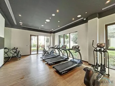 a gym with a row of treadmills and elliptical machines at Lavish 1BR Apartment at Summer at Creek Beach, Dubai Creek Harbor by Deluxe Holiday Homes in Dubai