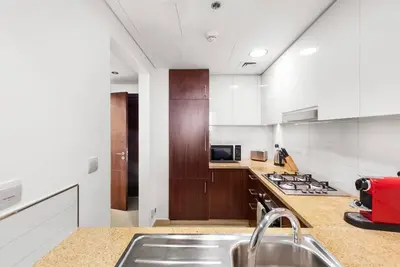 a kitchen with a sink and a stove top oven at FIRST CLASS 1BR Beautifully Furnished in Dubai