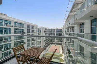 a balcony with a table and chairs on a building at StoneTree - Furnished 1 BR - Glitz 3 in Dubai
