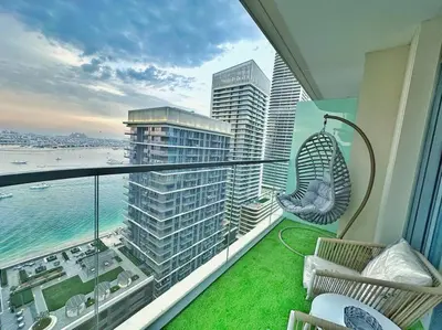 a balcony with a hammock and a view of the ocean at Your Private Beach Sunny Retreat in Dubai