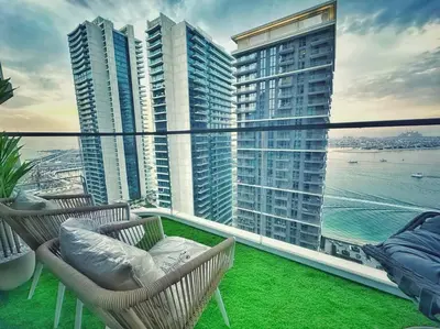 a balcony with chairs and a view of the ocean at Your Private Beach Sunny Retreat in Dubai