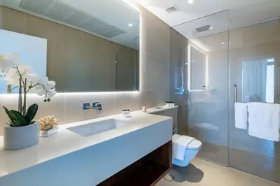 a bathroom with a sink and a toilet and a shower at FIRST CLASS 1BR High Floor with Magical View in Dubai