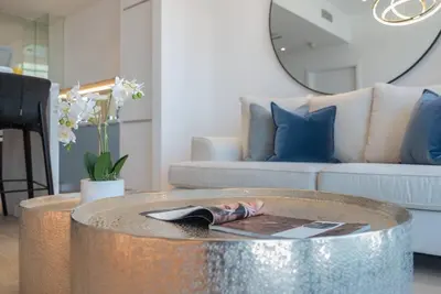 a living room with a table with a magazine on it at FIRST CLASS 1BR High Floor with Magical View in Dubai