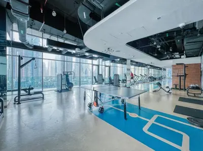 a gym with a table and some exercise equipment at FIRST CLASS 1BR High Floor with Magical View in Dubai