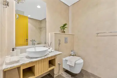 a bathroom with a sink and a toilet at High Floor Burj Khalifa & Sea View with stunning Infinity Pool in Dubai
