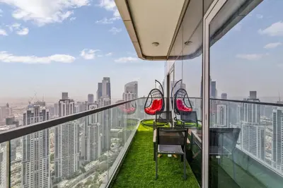 a room with a view of the city from the observation deck of a building at High Floor Burj Khalifa & Sea View with stunning Infinity Pool in Dubai