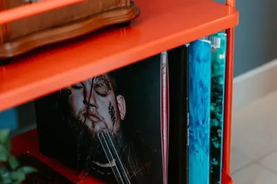 a red book shelf with books on it at Stylish 2-Bedroom Escape near Dubai Mall in Dubai