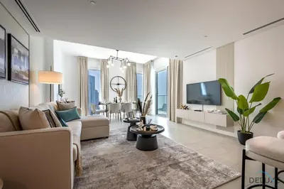 a living room with a couch and a tv at Elegant 2BR Apartment in La Vie, JBR by Deluxe Holiday Homes in Dubai