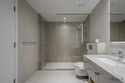 a bathroom with a shower and a toilet and a sink at Elegant 2BR Apartment in La Vie, JBR by Deluxe Holiday Homes in Dubai