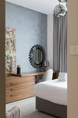 a bedroom with a bed and a mirror on the wall at Fabulous 1BR apartment in Address Beach Resort in Dubai