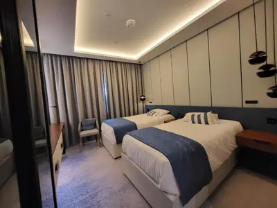 a hotel room with two beds and a window at Bluewaters Island - Modern 2 bedroom Full Apartment in Dubai