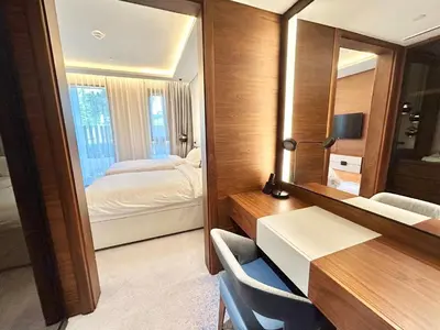 a hotel room with a bedroom and a mirror at Bluewaters Island - Modern 2 bedroom Full Apartment in Dubai