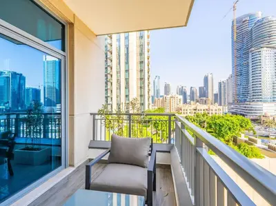 a balcony with a chair and a view of a city at Modern Downtown Escape 1Bedroom with Upscale Comfort in Dubai