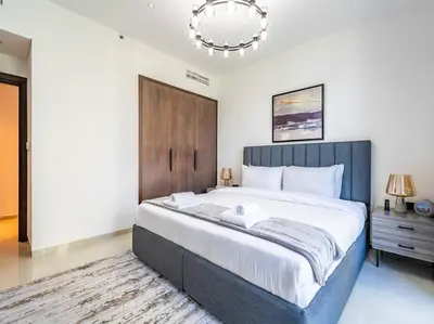 a bedroom with a large bed and a chandelier at Modern Downtown Escape 1Bedroom with Upscale Comfort in Dubai
