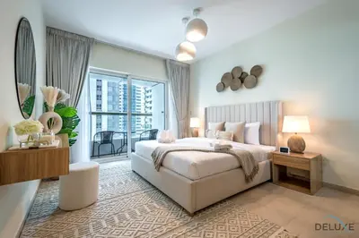 a bedroom with a large bed and a balcony at Modern 1BR Apartment in Elite Residences, Dubai Marina by Deluxe Holiday Homes in Dubai