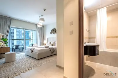 a bedroom with a bed and a bathroom at Modern 1BR Apartment in Elite Residences, Dubai Marina by Deluxe Holiday Homes in Dubai