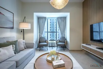a living room with a couch and a tv at Modern 1BR Apartment in Elite Residences, Dubai Marina by Deluxe Holiday Homes in Dubai