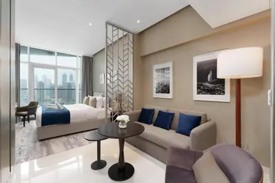 a living room with a couch and a bed at Your Dream Home in Damac Maison Prive by Suiteable in Dubai