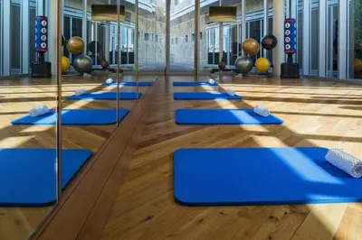 a row of blue mats on the floor of a gym at EMAAR Residences Fashion Avenue Full Burj Khalifa views Studio in Dubai