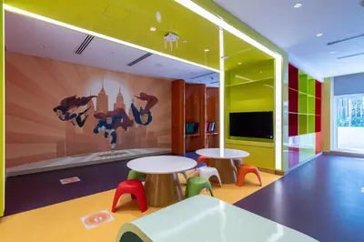 a room with two tables and a mural on the wall at GuestReady - Modern studio with Dubai Canal View in Dubai