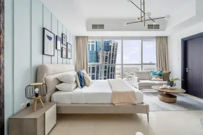 a bedroom with a bed and a living room at GuestReady - A Sanctuary Above the Clouds in Dubai