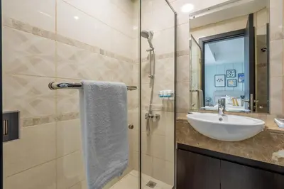 a bathroom with a sink and a shower at GuestReady - A Sanctuary Above the Clouds in Dubai