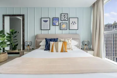 a bedroom with a bed with pillows and a window at GuestReady - A Sanctuary Above the Clouds in Dubai