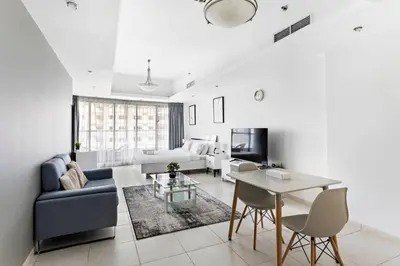 a living room with a couch and a table at Stylish Studio in Prime Location in Dubai