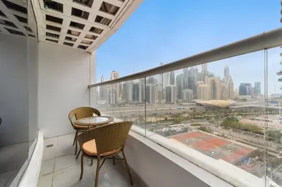 a balcony with two chairs and a view of a city at Stylish Studio in Prime Location in Dubai