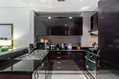 a kitchen with a sink and a counter top at FIRST CLASS 1BR in Royale Apartment on the Palm in Dubai