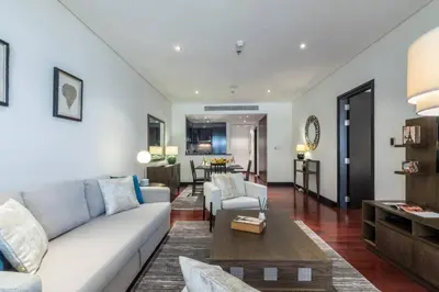 a living room with a couch and a table at FIRST CLASS 1BR in Royale Apartment on the Palm in Dubai