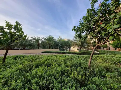 a park with trees and bushes in a park at YALLA REMRAAM in Dubai