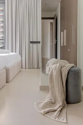 a bedroom with a bed and a blanket on the floor at Luxurious 4BR Apartment w/ Prime Burj Khalifa View in Dubai