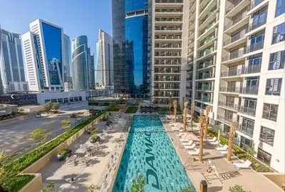 a view of a pool in a city with tall buildings at Modern Brand New 1 BR Apartment in ZADA Tower in Dubai