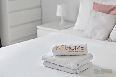 a pile of towels sitting on top of a bed at WelHome - Stylish Studio with Park Views in Regent House 2 in Dubai