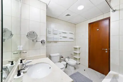a bathroom with a sink and a toilet at WelHome - Stylish Studio with Park Views in Regent House 2 in Dubai