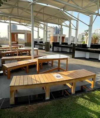 a group of tables and benches under a pavilion at Magnificent studio-One of kind in Dubai in Dubai